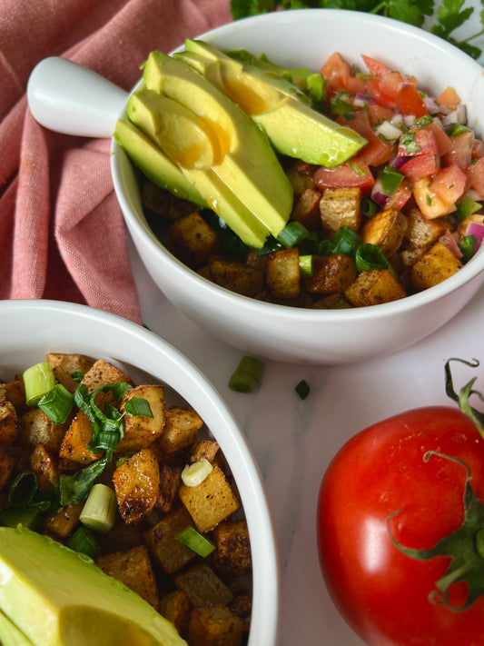 Crispy breakfast potatoes with fresh pico de gallo, creamy avocado, and green onions, served as a hearty breakfast